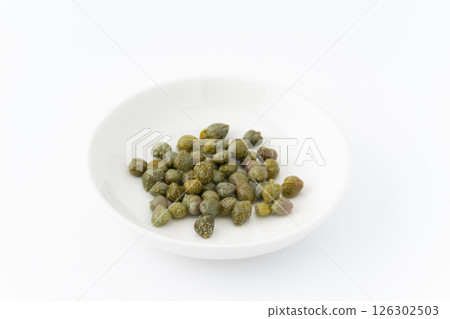 Pickled capers on a plate on a white background 126302503