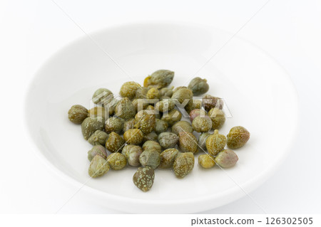 Pickled capers on a plate on a white background 126302505