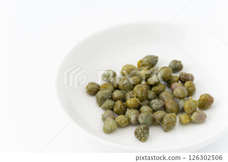 Pickled capers on a plate on a white background 126302506