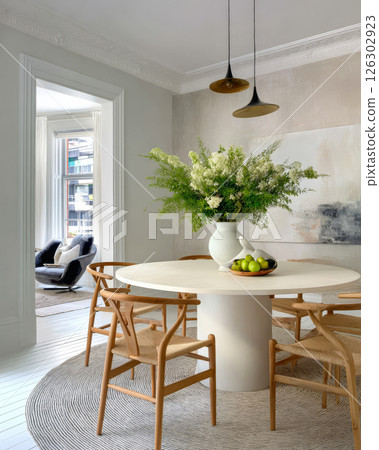 Elegant dining area with natural decor and modern furnishings in bright light 126302923