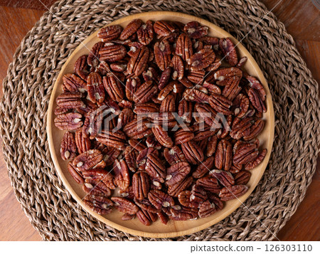 raw organic pecan nuts pattern background. raw organic pecan nuts pattern background. 126303110