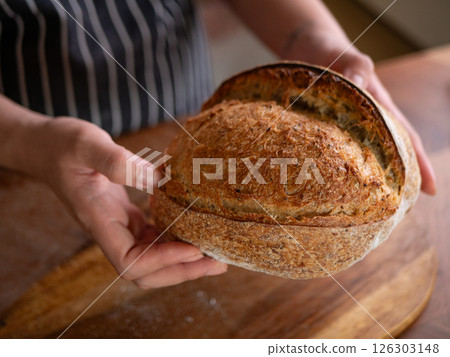 Artisan Sourdough Bread in Hand  Fresh from the Oven. 126303148
