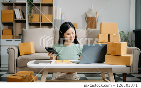 Startup small business SME, Entrepreneur owner woman using smartphone or tablet taking receive and checking online purchase shopping orde Startup small business SME, Entrepreneur owner woman using smartphone or tablet taking receive and checking online purchase shopping orde 126303371