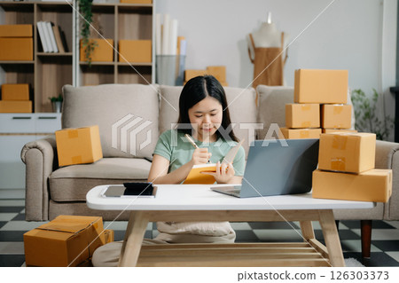 Startup small business SME, Entrepreneur owner woman using smartphone or tablet taking receive and checking online purchase shopping orde Startup small business SME, Entrepreneur owner woman using smartphone or tablet taking receive and checking online purchase shopping orde 126303373