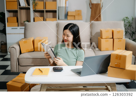 Small business entrepreneur SME freelance woman working at home office, BOX,tablet and laptop online, marketing, packaging, delivery 126303392