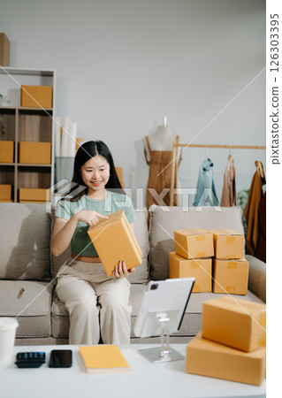 Small business entrepreneur SME freelance woman working at home office, BOX,tablet and laptop online, marketing, packaging, delivery Small business entrepreneur SME freelance woman working at home office, BOX,tablet and laptop online, marketing, packaging, delivery 126303395