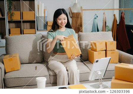 Small business entrepreneur SME freelance woman working at home office, BOX,tablet and laptop online, marketing, packaging, delivery 126303396