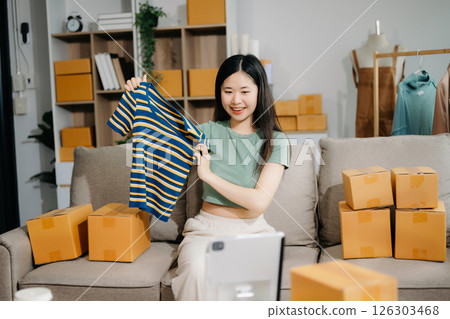Fashion blogger concept, Young Asian women selling clothes on video streaming.Startup small business SME 126303468