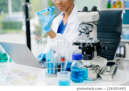 female scientist working with micro pipettes analyzing biochemical samples, advanced science chemical laboratory female scientist working with micro pipettes analyzing biochemical samples, advanced science chemical laboratory 126303485