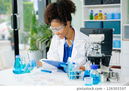 female scientist working with micro pipettes analyzing biochemical samples, advanced science chemical laboratory female scientist working with micro pipettes analyzing biochemical samples, advanced science chemical laboratory 126303597
