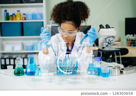 female scientist working with micro pipettes analyzing biochemical samples, advanced science chemical laboratory 126303659