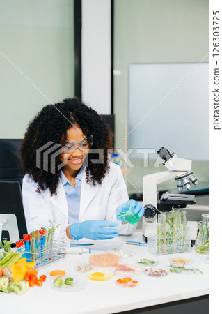 Food science as lab scientists test and analyze vegetables for safety and quality using advanced technology Food science as lab scientists test and analyze vegetables for safety and quality using advanced technology 126303725