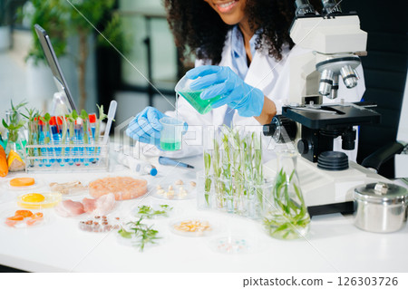Food science as lab scientists test and analyze vegetables for safety and quality using advanced technology 126303726