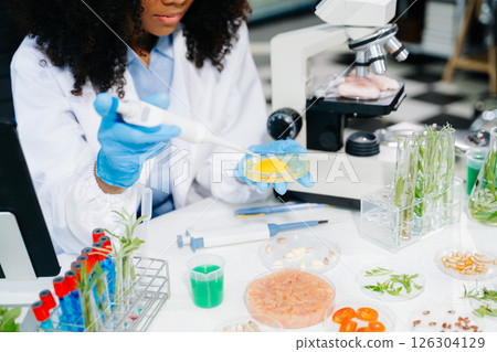 Food science as lab scientists test and analyze vegetables for safety and quality using advanced technology Food science as lab scientists test and analyze vegetables for safety and quality using advanced technology 126304129