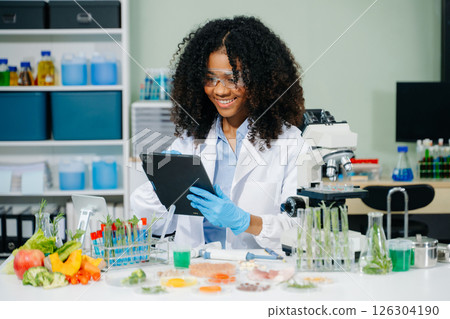 Food science as lab scientists test and analyze vegetables for safety and quality using advanced technology 126304190