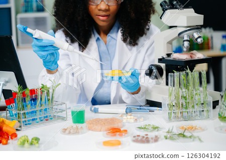 Food science as lab scientists test and analyze vegetables for safety and quality using advanced technology 126304192
