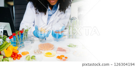 Food science as lab scientists test and analyze vegetables for safety and quality using advanced technology 126304194
