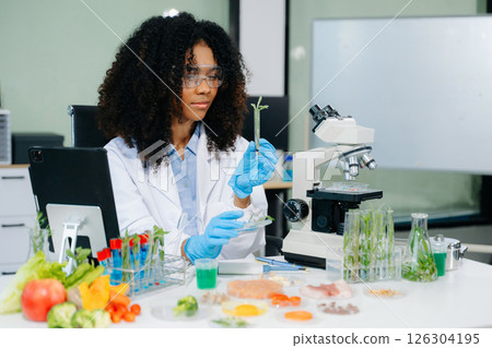 Food science as lab scientists test and analyze vegetables for safety and quality using advanced technology Food science as lab scientists test and analyze vegetables for safety and quality using advanced technology 126304195