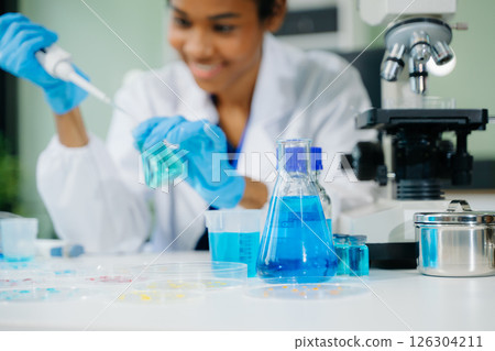 Young scientists conducting research investigations in a medical laboratory, a researcher in the foreground 126304211