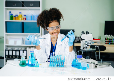 Young scientists conducting research investigations in a medical laboratory, a researcher in the foreground 126304212