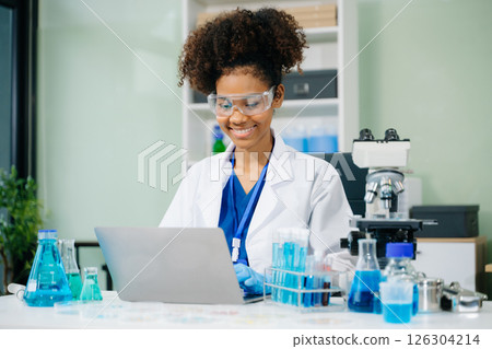 female scientist working with micro pipettes analyzing biochemical samples, advanced science chemical laboratory 126304214