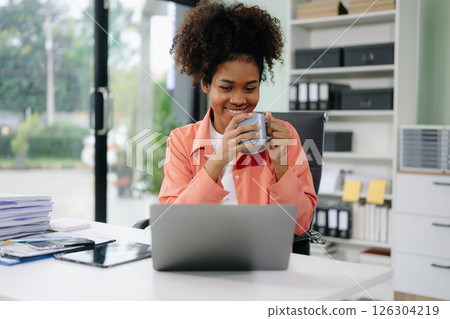 Young businesswoman working with working notepad, tablet and laptop documents talking on the smartphone, tablet 126304219
