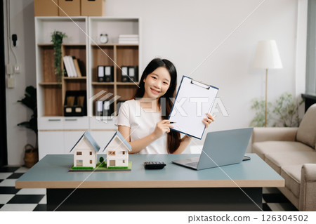 Considering buying a home, investing in real estate. Broker signs a sales agreement. agent, lease agreement, successful deal Considering buying a home, investing in real estate. Broker signs a sales agreement. agent, lease agreement, successful deal 126304502