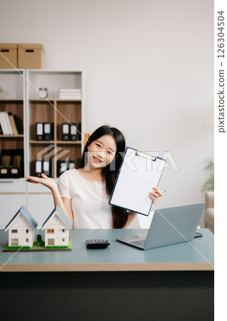 Considering buying a home, investing in real estate. Broker signs a sales agreement. agent, lease agreement, successful deal Considering buying a home, investing in real estate. Broker signs a sales agreement. agent, lease agreement, successful deal 126304504