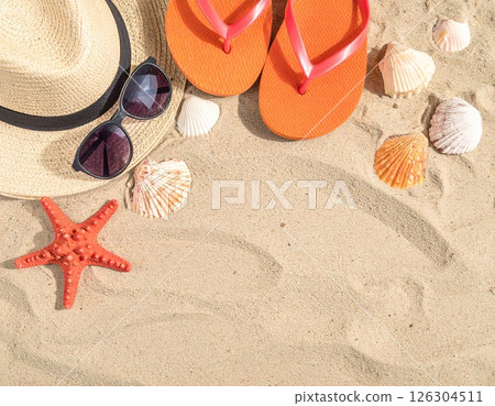 A summer vacation image with straw hats, sunglasses, sandals and seashells on the sandy beach 126304511