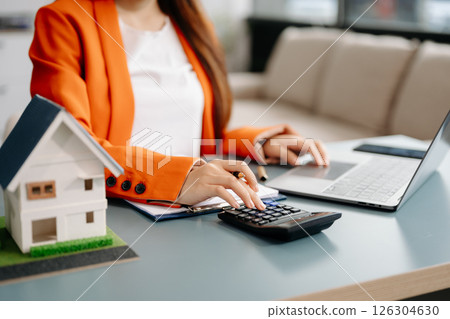 Considering buying a home, investing in real estate. Broker signs a sales agreement. agent, lease agreement, successful deal Considering buying a home, investing in real estate. Broker signs a sales agreement. agent, lease agreement, successful deal 126304630