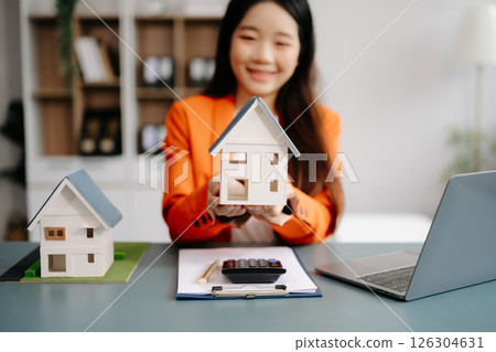 Considering buying a home, investing in real estate. Broker signs a sales agreement. agent, lease agreement, successful deal Considering buying a home, investing in real estate. Broker signs a sales agreement. agent, lease agreement, successful deal 126304631