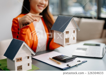 Considering buying a home, investing in real estate. Broker signs a sales agreement. agent, lease agreement, successful deal 126304633