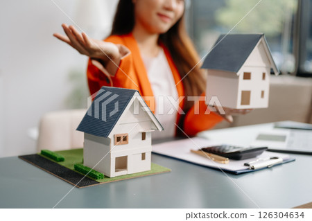 Considering buying a home, investing in real estate. Broker signs a sales agreement. agent, lease agreement, successful deal 126304634