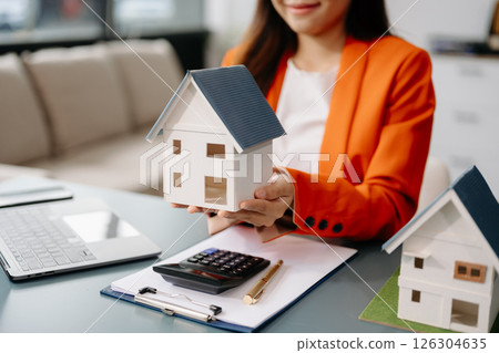 Considering buying a home, investing in real estate. Broker signs a sales agreement. agent, lease agreement, successful deal 126304635