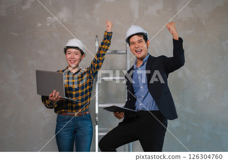 Successful engineer teams working together wear worker helmets hardhat on construction site. Successful engineer teams working together wear worker helmets hardhat on construction site. 126304760
