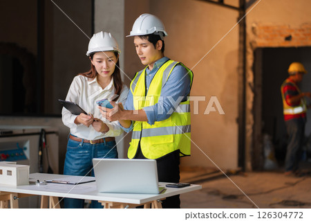 Engineer teams meeting working together wear worker helmets hardhat on construction site. Engineer teams meeting working together wear worker helmets hardhat on construction site. 126304772