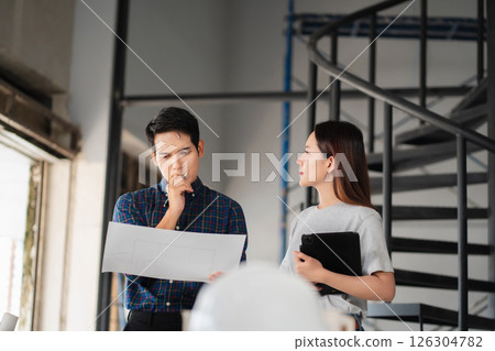 civil engineer and worker discussing issues at the construction site. civil engineer and worker discussing issues at the construction site. 126304782