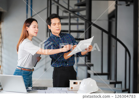 civil engineer and worker discussing issues at the construction site. civil engineer and worker discussing issues at the construction site. 126304783