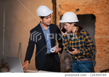 Engineering Team Collaborates on Blueprint Model in Corporate Office. 126304784