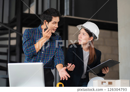 Construction engineers discussion with architects at construction site or building site. 126304793