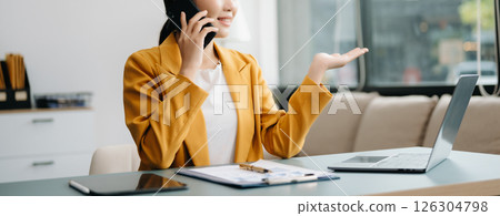 Businesswoman Analyzing Finance on Tablet and Laptop at modern Office Desk tax, report, accounting, statistics, and analytical research concept Businesswoman Analyzing Finance on Tablet and Laptop at modern Office Desk tax, report, accounting, statistics, and analytical research concept 126304798