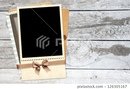 Retro photo frame and card, creating a nostalgic effect. Vintage scrapbooking style. Horizontal background with retro photo on old wooden boards. Mock up template. Copy space for text 126305167