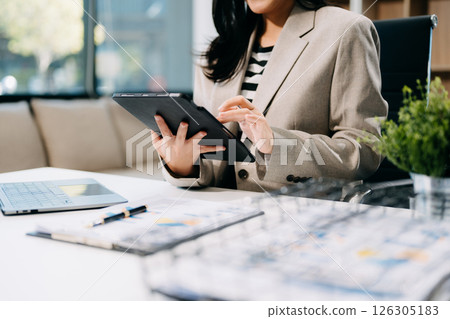 Confident businessman working on laptop,tablet and smartphone at her workplace 126305183