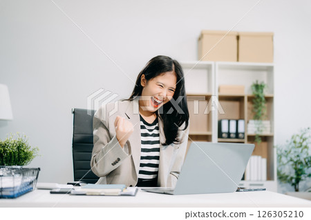 Asian business woman are delighted and happy with the work they do on their tablet, laptop 126305210