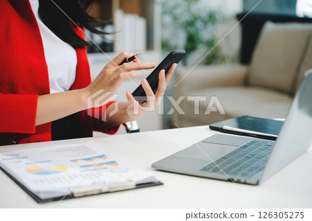Businesswoman utilizing smartphone and tablet technology. Perfect for corporate, technology Businesswoman utilizing smartphone and tablet technology. Perfect for corporate, technology 126305275