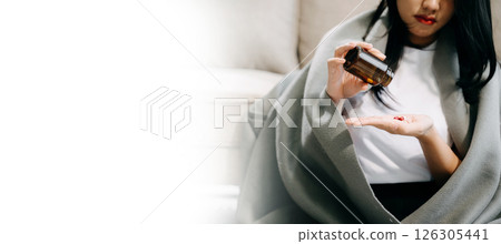 woman holding bottle with pills on hand going to take medicaments prescribed woman holding bottle with pills on hand going to take medicaments prescribed 126305441