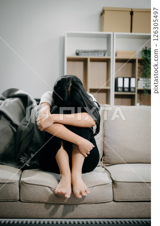 woman sit Depression Dark haired pensive glance Standing by window and anxiety Copy space. woman sit Depression Dark haired pensive glance Standing by window and anxiety Copy space. 126305497
