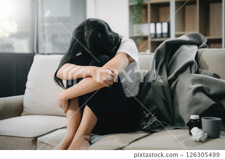 woman sit Depression Dark haired pensive glance Standing by window and anxiety Copy space. woman sit Depression Dark haired pensive glance Standing by window and anxiety Copy space. 126305499