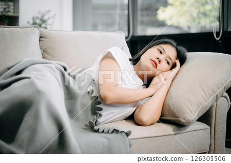 woman sit Depression Dark haired pensive glance Standing by window and anxiety Copy space. woman sit Depression Dark haired pensive glance Standing by window and anxiety Copy space. 126305506
