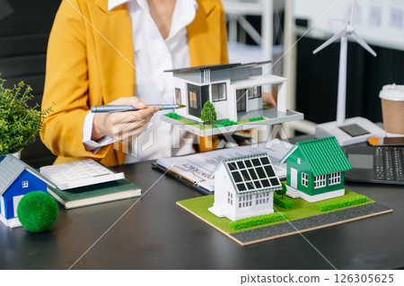 Real estate broker agent presenting and consult to customer to decision making sign insurance form agreement, home model Real estate broker agent presenting and consult to customer to decision making sign insurance form agreement, home model 126305625